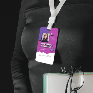 Printed ID card hanging around neck of a staff member on a white lanyard.