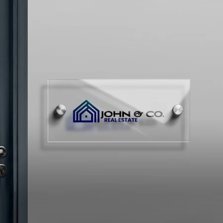 acrylic sign for real estate company mounted onto wall