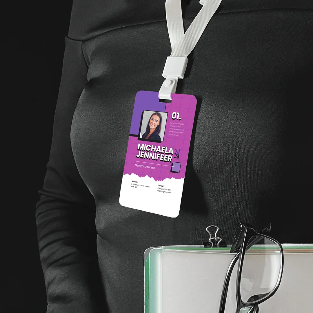 Printed ID card hanging around neck of a staff member on a white lanyard.